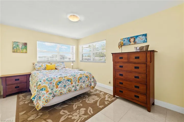 Bedroom with light tile patterned floors and baseboards