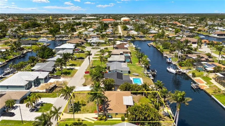 Birds eye view of property with a residential view and a water view