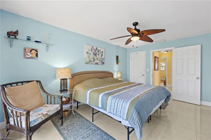 Bedroom featuring baseboards, visible vents, and ceiling fan