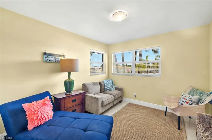 Living area featuring carpet and baseboards