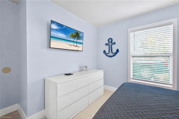 Bedroom featuring light tile patterned flooring and baseboards