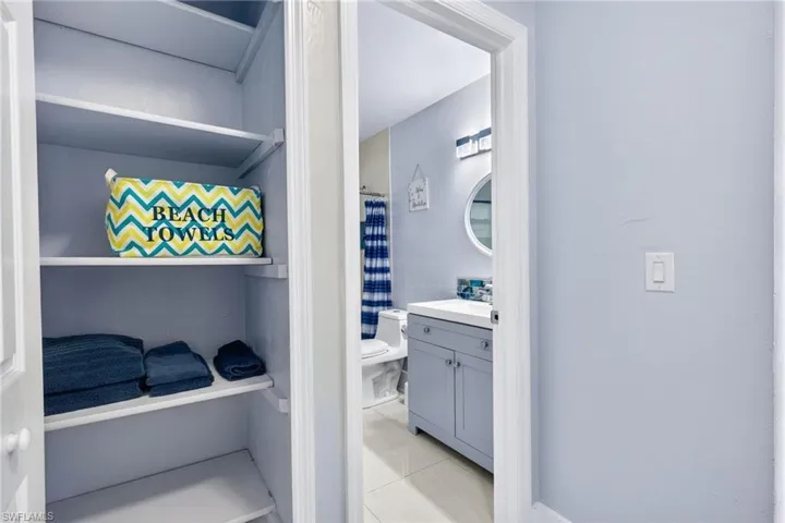 Bathroom with vanity, curtained shower, and light tile patterned floors