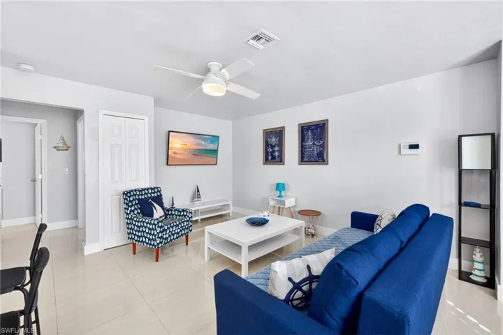 Living room featuring ceiling fan and light tile patterned floors