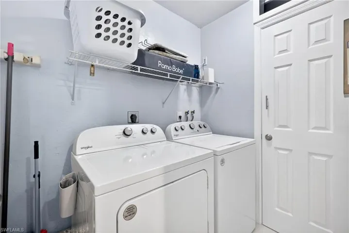 Laundry area featuring washing machine and clothes dryer