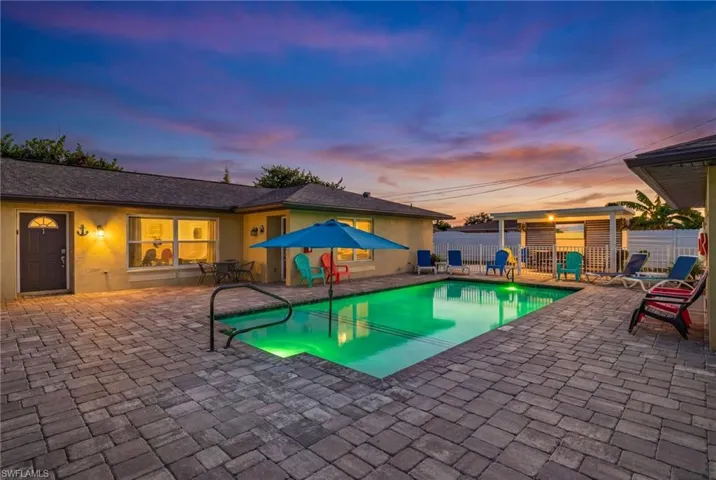 Pool at dusk with a patio area