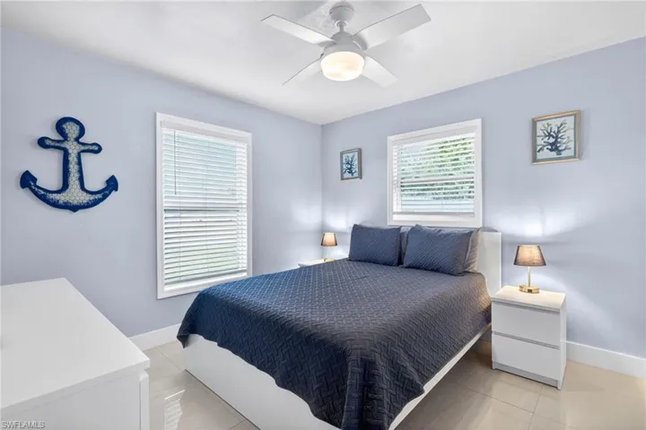 Bedroom featuring light tile patterned floors and ceiling fan