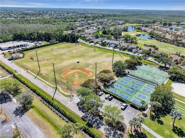 Expansive aerial showcasing multiple sports courts, a baseball diamond, and a large open field