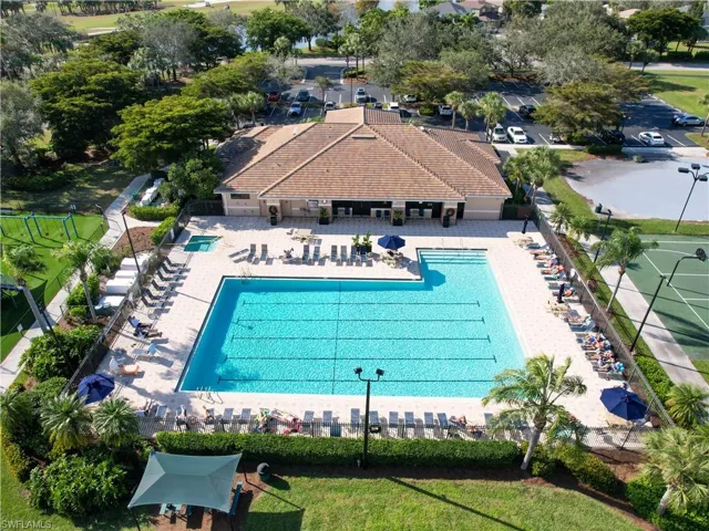 Community pool with a tiled deck, integrated spa, and a surrounding lounge area