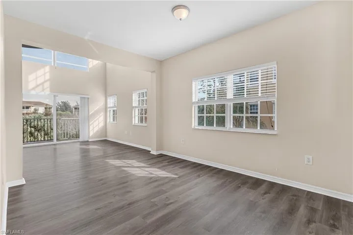 Spare room with dark wood finished floors and baseboards