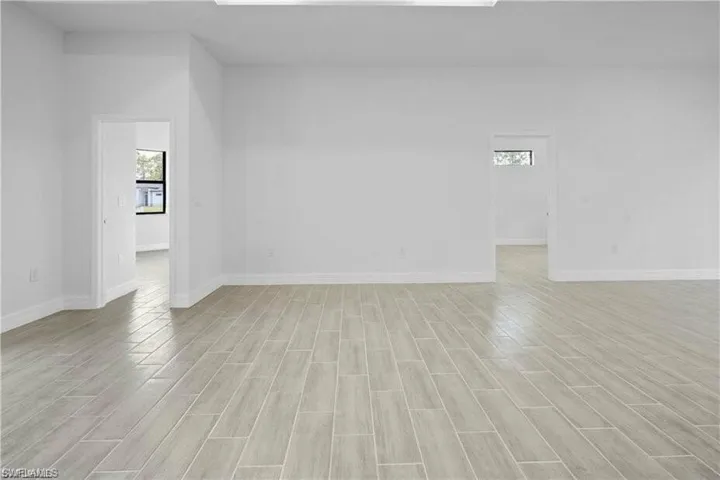 Spare room featuring light wood finished floors and baseboards