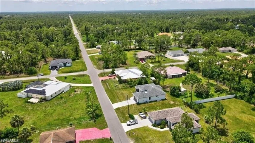 Aerial perspective of suburban area with a heavily wooded area