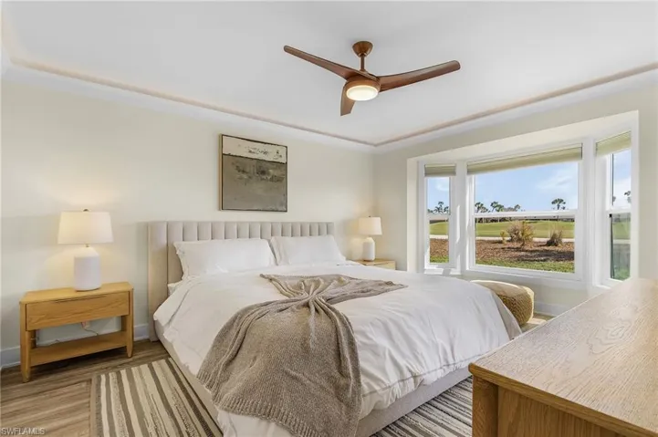 Master Bedroom featuring LVT flooring, ornamental molding, and ceiling fan