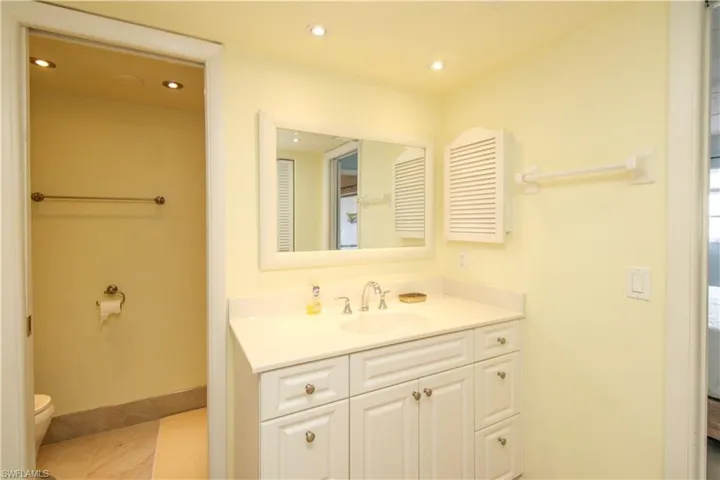 Bathroom with vanity, toilet, and tile patterned flooring