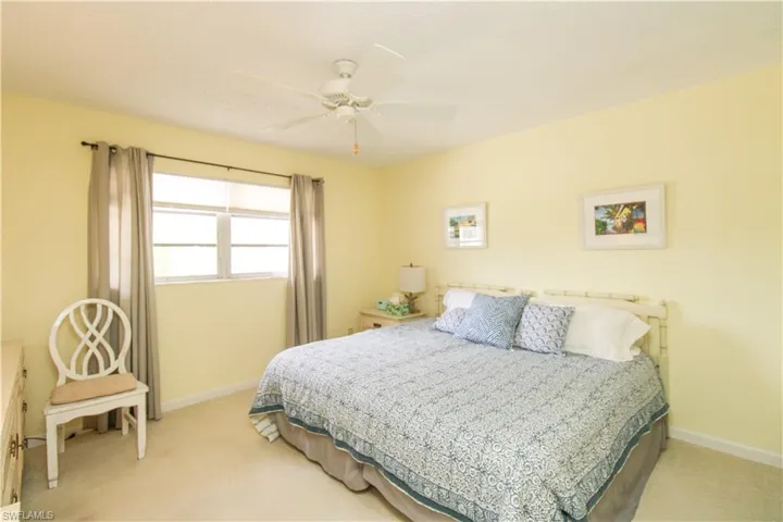 Bedroom featuring light carpet and ceiling fan