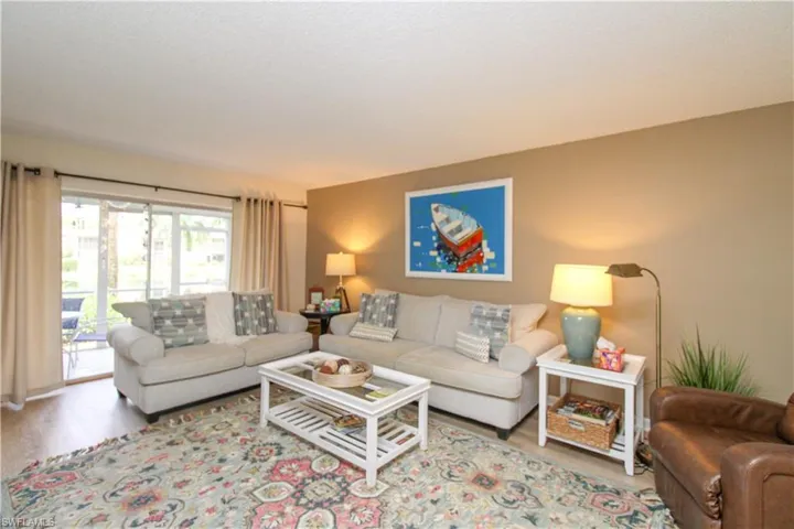 Living room with light hardwood / wood-style floors