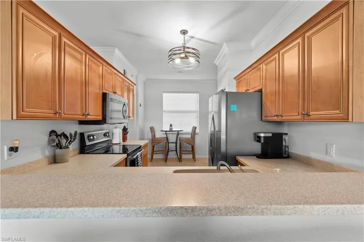 Kitchen featuring Maple cabinets, Corian Counters, newer stainless appliances, updated lighting.