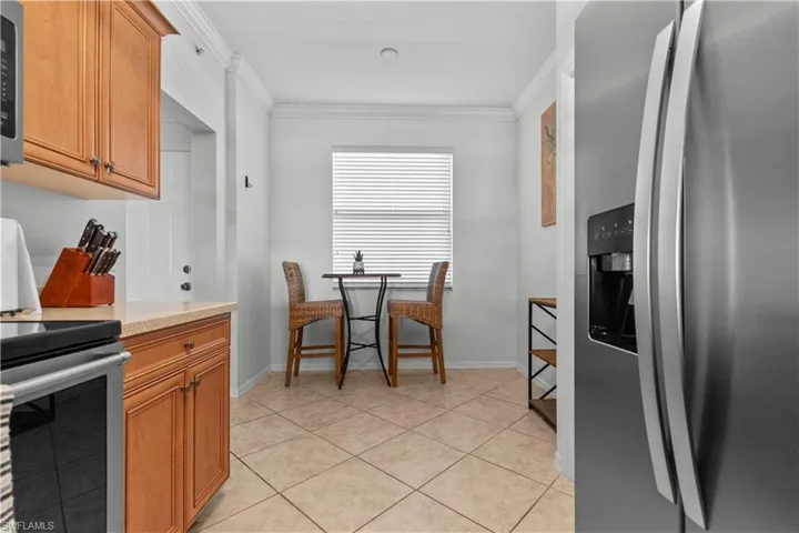 Kitchen area featuring Maple cabinetry,Corian countertops, and newer stainless steel appliances