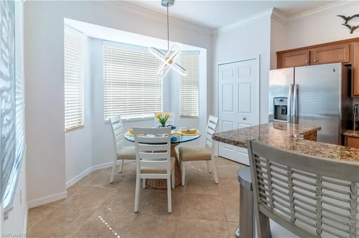Dining area with ornamental molding and baseboards