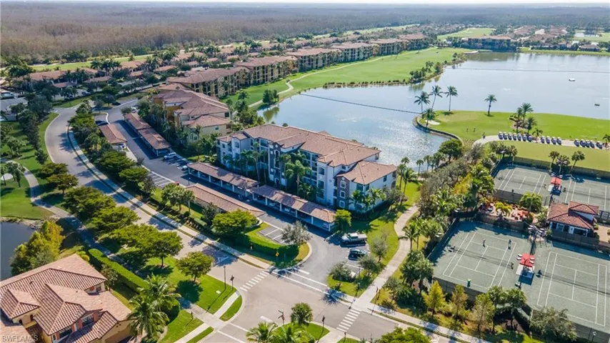 Aerial view of residential area with a large body of water and a golf course