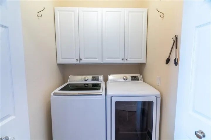 Laundry area with cabinet space and washer and dryer