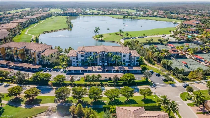 Drone / aerial view of a nearby body of water and a golf club