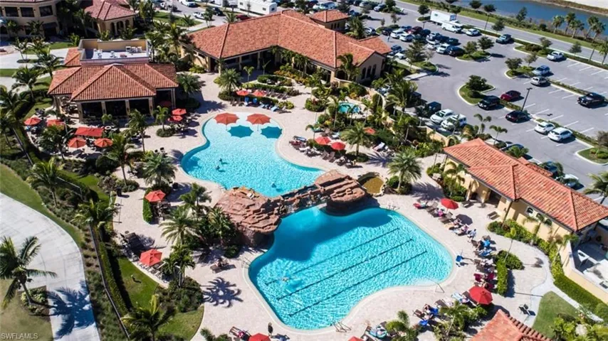 Drone / aerial view of a pool and a nearby body of water