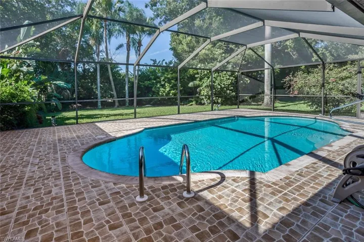 View of swimming pool featuring a lanai and a patio