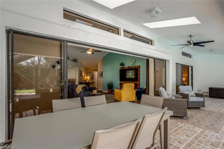 Dining area featuring ceiling fan and a skylight