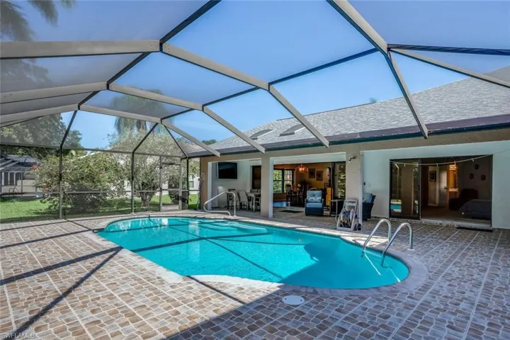 View of pool featuring large TV newly resurfaced and tiled pool!