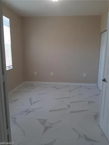 Unfurnished room featuring a wealth of natural light