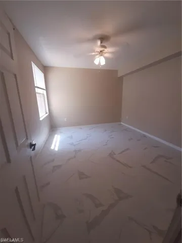 Unfurnished room featuring ceiling fan