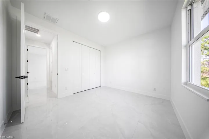 Unfurnished room featuring baseboards