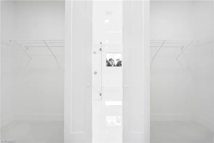 Bathroom with a marble finish shower, vanity, and recessed lighting