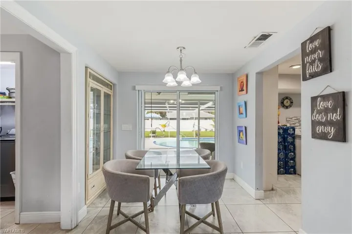 Tiled dining space with a notable chandelier