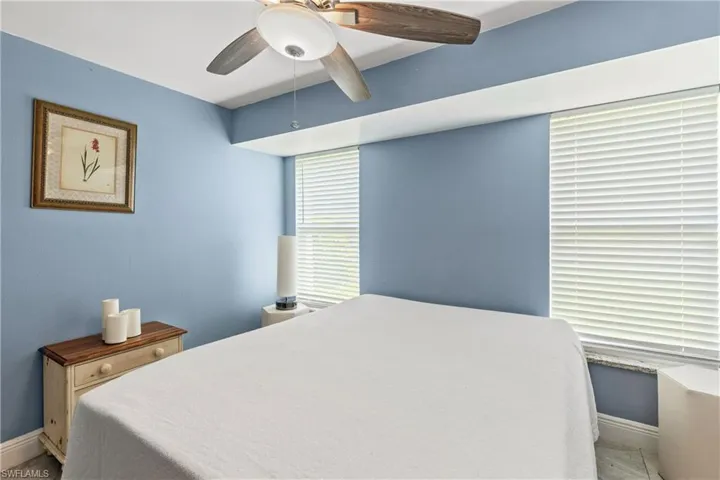 Bedroom featuring light tile patterned floors and ceiling fan
