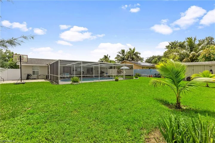 View of yard featuring a patio and glass enclosure
