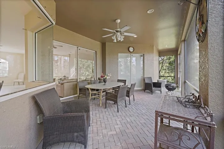 Sunroom featuring brick floors, a textured wall, and recessed lighting
