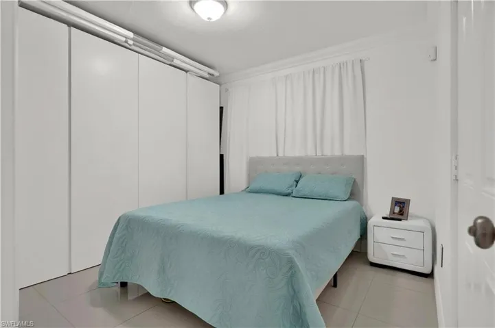 Bedroom with light tile patterned flooring