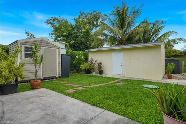 View of yard featuring a patio and a storage unit