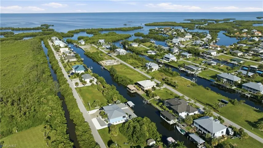 Waterfront community with direct Gulf access, residential canal access, and lush green landscaping