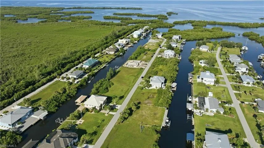 Waterfront properties with direct canal access, surrounded by lush green landscapes and open water