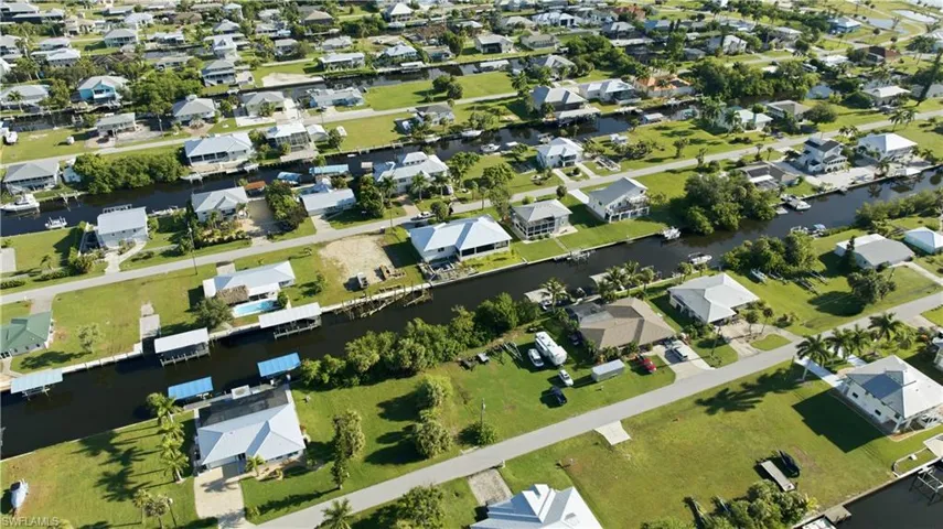 Canal-front homes with private boat docks and surrounding green spaces