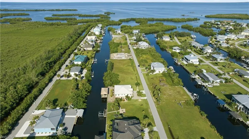 Waterfront community featuring direct canal access, established residences, and undeveloped lots