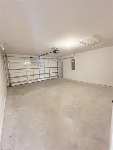 Garage with electric panel and a garage door opener