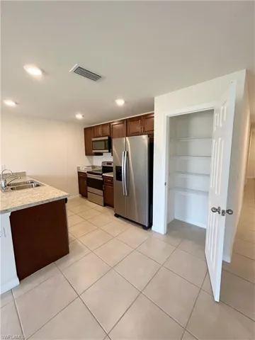 Kitchen featuring visible vents, a sink, recessed lighting, appliances with stainless steel finishes, and light tile patterned floors