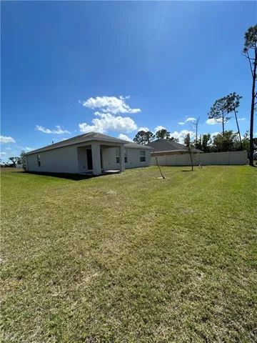 View of yard featuring fence