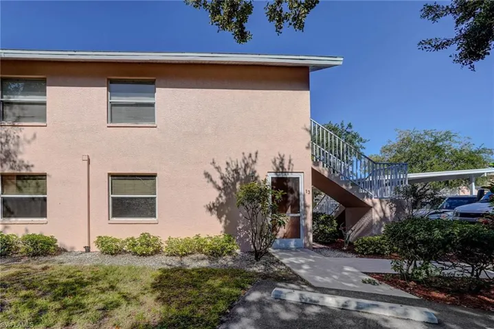 View of property with stairs