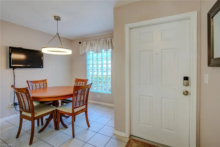 Dining room featuring baseboards and light tile patterned flooring