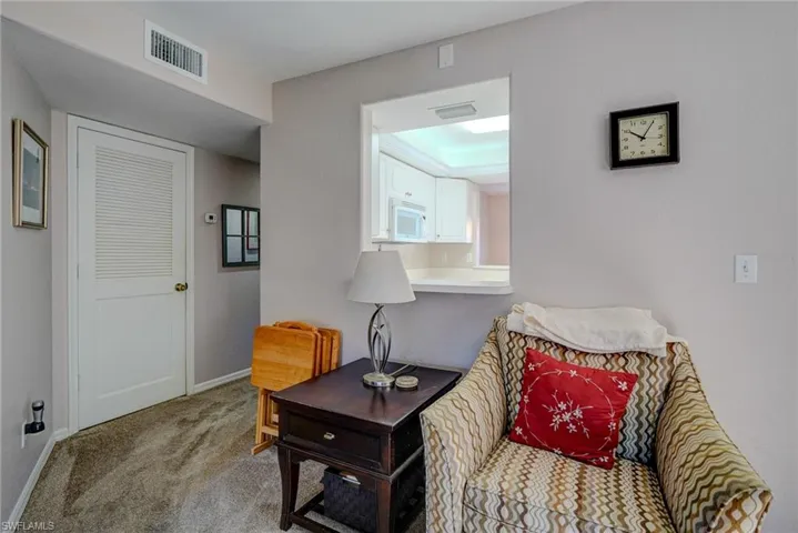 Sitting room with carpet floors, visible vents, and baseboards