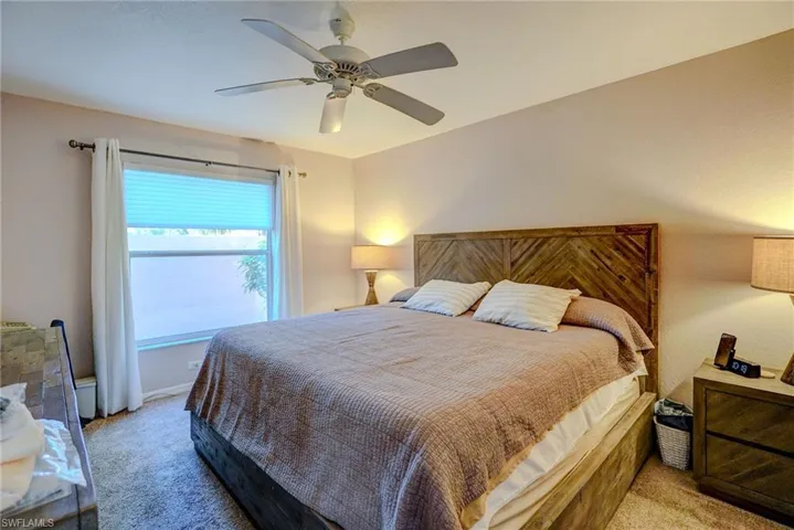 Bedroom featuring light carpet and a ceiling fan